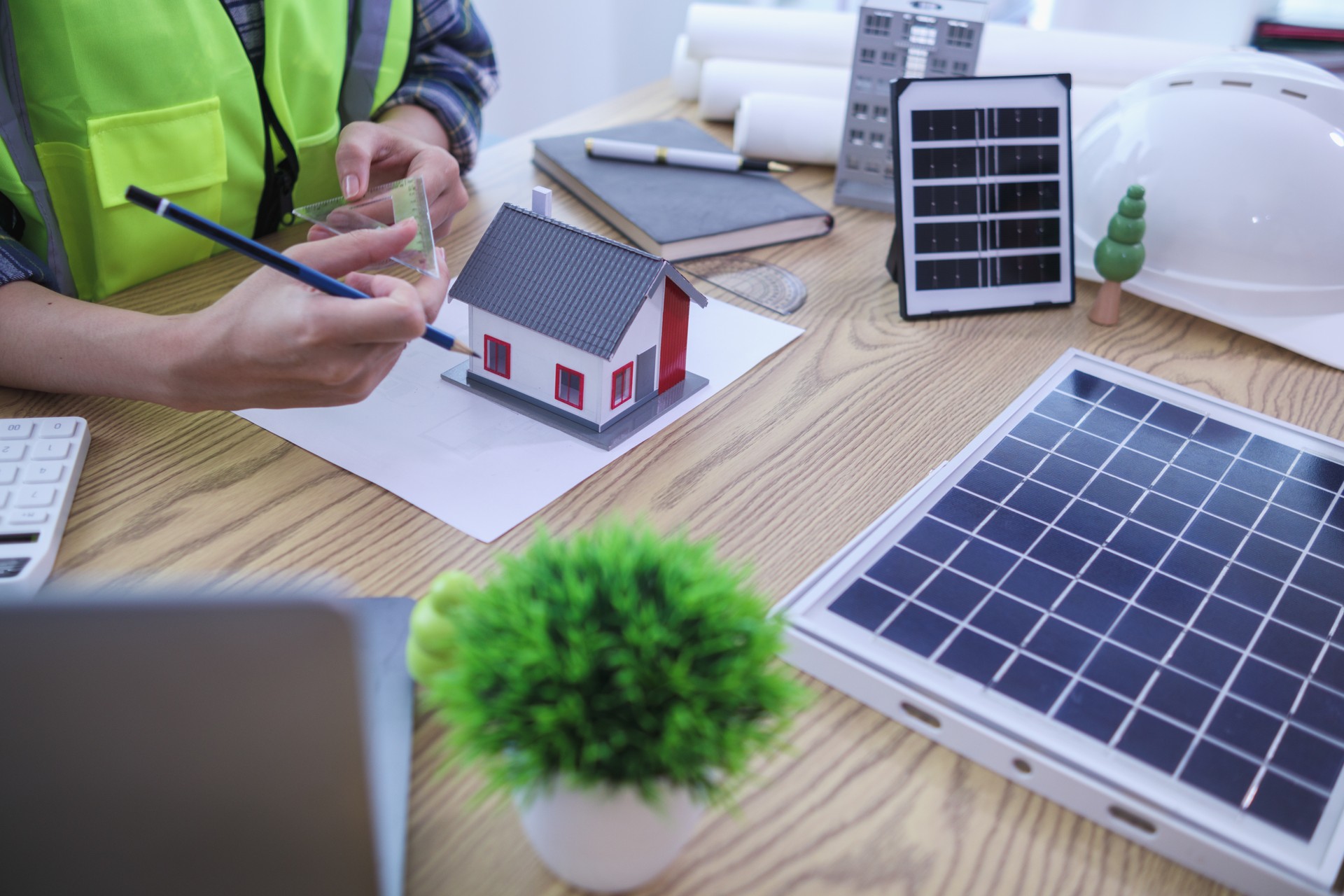 Engineers are reviewing plans from architects to prepare to install solar panels and wind turbines on the building to efficiently produce electricity using the concept of green energy from solar cells